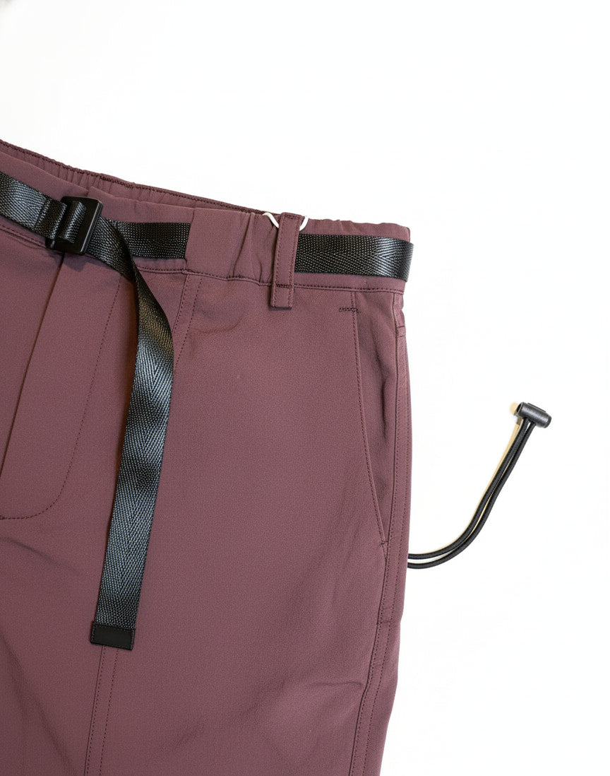 Maroon pants with a black belt and a metal hook on a white background