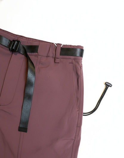 Maroon pants with a black belt and a metal hook on a white background